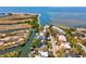 Aerial view of waterfront home with dock, canal access, and bay views at 4834 W Flamingo Rd, Tampa, FL 33611