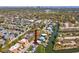 Aerial view of home with neighborhood, canal access, and skyline in the distance at 4834 W Flamingo Rd, Tampa, FL 33611