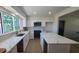 Bright, updated kitchen with quartz countertops, stainless appliances, island, and white cabinetry at 4834 W Flamingo Rd, Tampa, FL 33611