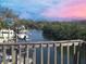 Serene waterway view with boats docked nearby, seen from a charming wooden fenced deck at 4834 W Flamingo Rd, Tampa, FL 33611