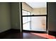 A view from inside showing a partially screened-in balcony with red floors and an exterior chair at 4983 Puritan Cir # 524, Tampa, FL 33617
