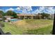 View from an apartment window of a community pool and manicured green space at 4983 Puritan Cir # 524, Tampa, FL 33617