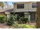 Exterior view of the home's screened lanai and backyard, surrounded by mature trees and lush landscaping at 5100 Burchette Rd # 1606, Tampa, FL 33647