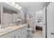Well-lit bathroom featuring tile countertop with access to the Primary bedroom at 5100 Burchette Rd # 1606, Tampa, FL 33647