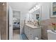 Bathroom featuring double vanity, large mirror, and decorative sconces, with access to the bedroom at 5100 Burchette Rd # 1606, Tampa, FL 33647