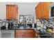 Kitchen with stainless steel dishwasher, granite counters, and dark wood cabinets at 5100 Burchette Rd # 1606, Tampa, FL 33647