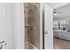 Shower with hand-held shower-head attachment with access to Primary bedroom with neutral tones at 5100 Burchette Rd # 1606, Tampa, FL 33647
