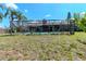 Backyard featuring a screened-in pool, grass, and a view of the home at 5101 Estates Cir, Sarasota, FL 34243