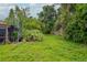 Backyard with a spiral staircase and lush greenery, surrounded by a wooden fence at 5101 Estates Cir, Sarasota, FL 34243