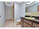 Bathroom featuring a yellow sink, coordinating toilet, and walk-in shower with glass door at 5101 Estates Cir, Sarasota, FL 34243