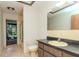Bathroom featuring a shower, toilet, vanity and a door to the exterior at 5101 Estates Cir, Sarasota, FL 34243