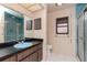Bathroom featuring a blue sink, shower and window at 5101 Estates Cir, Sarasota, FL 34243