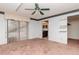 Bedroom features sliding glass doors, a ceiling fan, and shelving at 5101 Estates Cir, Sarasota, FL 34243