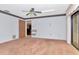 Spacious bedroom with a ceiling fan, closet, and sliding glass door to the outdoors at 5101 Estates Cir, Sarasota, FL 34243