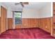 Cozy bedroom with wood paneling, a window view, and built-in shelving at 5101 Estates Cir, Sarasota, FL 34243