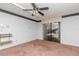 Bedroom features sliding glass doors, a ceiling fan, and shelving at 5101 Estates Cir, Sarasota, FL 34243