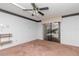 Bedroom featuring a ceiling fan, sliding glass doors, and wall shelving at 5101 Estates Cir, Sarasota, FL 34243