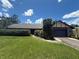 Charming single-story home with a two-car garage, green grass, and well-maintained bushes at 5101 Estates Cir, Sarasota, FL 34243