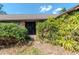 Exterior entrance to house surrounded by hedges and mature foliage at 5101 Estates Cir, Sarasota, FL 34243
