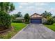 Inviting single-story home with a well-maintained lawn, large driveway, and attached two-car garage at 5101 Estates Cir, Sarasota, FL 34243