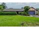 Charming single-story home featuring a lush front lawn, a blue two-car garage and an inviting entryway at 5101 Estates Cir, Sarasota, FL 34243