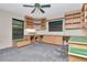 Office space featuring a ceiling fan, natural light, and built-in desks and cabinets at 5101 Estates Cir, Sarasota, FL 34243