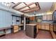 A kitchen featuring wood cabinets, brick floor and center island at 5101 Estates Cir, Sarasota, FL 34243