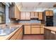 Kitchen featuring wood cabinets, a center island, brick floor and stainless steel sink at 5101 Estates Cir, Sarasota, FL 34243
