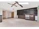 Spacious living room with a beamed ceiling, built-in shelving, and a view of the foyer at 5101 Estates Cir, Sarasota, FL 34243