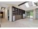 Living room featuring built-in shelving, a fireplace, and a sliding glass door leading to the patio at 5101 Estates Cir, Sarasota, FL 34243