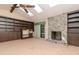 A cozy living room area with a fireplace, skylight and built-in bookshelves at 5101 Estates Cir, Sarasota, FL 34243