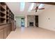 Living room with stone fireplace, built-in shelving and a skylight at 5101 Estates Cir, Sarasota, FL 34243