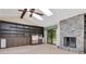 Spacious living room with stone fireplace, built-in shelving, and sliding doors for natural light at 5101 Estates Cir, Sarasota, FL 34243