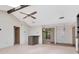Open living room featuring beamed ceilings, tiled floors, and a view of the foyer and doorway at 5101 Estates Cir, Sarasota, FL 34243