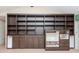 Living room featuring custom built-in shelving with cabinets and drawers at 5101 Estates Cir, Sarasota, FL 34243