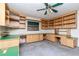 Office featuring built in shelving, green countertops, and a ceiling fan at 5101 Estates Cir, Sarasota, FL 34243