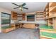 Office featuring built in shelving, green countertops, and a ceiling fan at 5101 Estates Cir, Sarasota, FL 34243