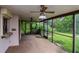 Enclosed patio with ceiling fans, providing a comfortable outdoor living space and backyard access at 5101 Estates Cir, Sarasota, FL 34243