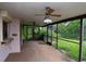 Enclosed patio with ceiling fans, providing a comfortable outdoor living space and backyard access at 5101 Estates Cir, Sarasota, FL 34243