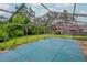 Enclosed pool area featuring a covered pool and views of the surrounding greenery at 5101 Estates Cir, Sarasota, FL 34243