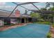 Outdoor pool covered, surrounded by a screened enclosure, with a view of the home's architecture at 5101 Estates Cir, Sarasota, FL 34243
