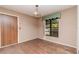 Room with a wood door, window with green accents and hard wood floors at 5101 Estates Cir, Sarasota, FL 34243