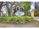 Eiland Park Townhomes community sign surrounded by lush greenery and mature trees, creating a welcoming entrance at 6262 Timberly Ln # 99, Zephyrhills, FL 33542