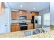 A kitchen view featuring stainless appliances, granite counters, and wood cabinetry at 6262 Timberly Ln # 99, Zephyrhills, FL 33542