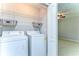 An open view of the laundry room with a washer, dryer, and wire shelving at 6262 Timberly Ln # 99, Zephyrhills, FL 33542