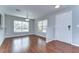 Bright living room with hardwood floors, large windows, and modern lighting fixtures, creating an inviting space at 6262 Timberly Ln # 99, Zephyrhills, FL 33542