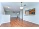 Spacious living room with hardwood floors, an open layout, and direct access to the kitchen area at 6262 Timberly Ln # 99, Zephyrhills, FL 33542