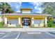 Community mail kiosk featuring stone accents, yellow painted walls, and convenient parking for easy access at 6262 Timberly Ln # 99, Zephyrhills, FL 33542