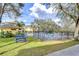 Scenic view of the community pool area with picnic tables, lush greenery, and a relaxing atmosphere at 6262 Timberly Ln # 99, Zephyrhills, FL 33542