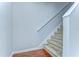 A carpeted staircase with white walls and trim, offering a simple and clean design at 6262 Timberly Ln # 99, Zephyrhills, FL 33542